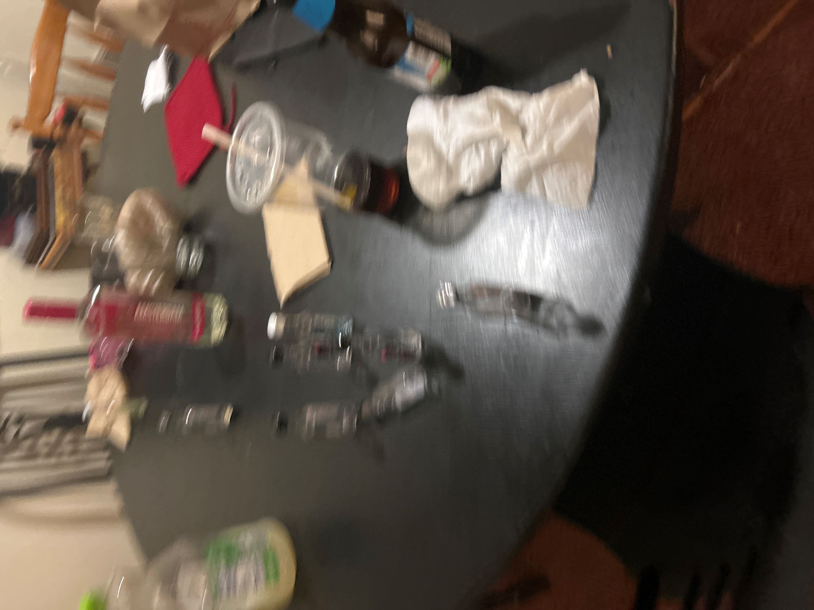 Blurry image of empty beer bottles and shooters.